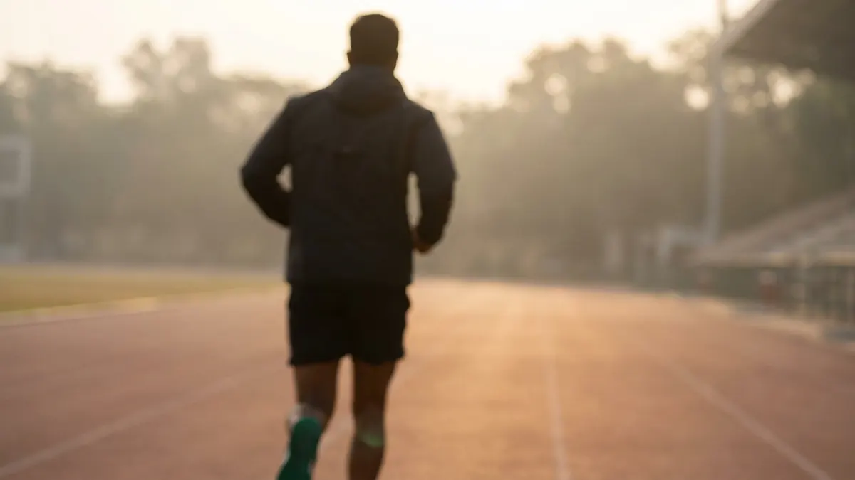 אדם רץ על מסלול ריצה באצטדיון, הערכת VO2max בעזרת מבחן קופר